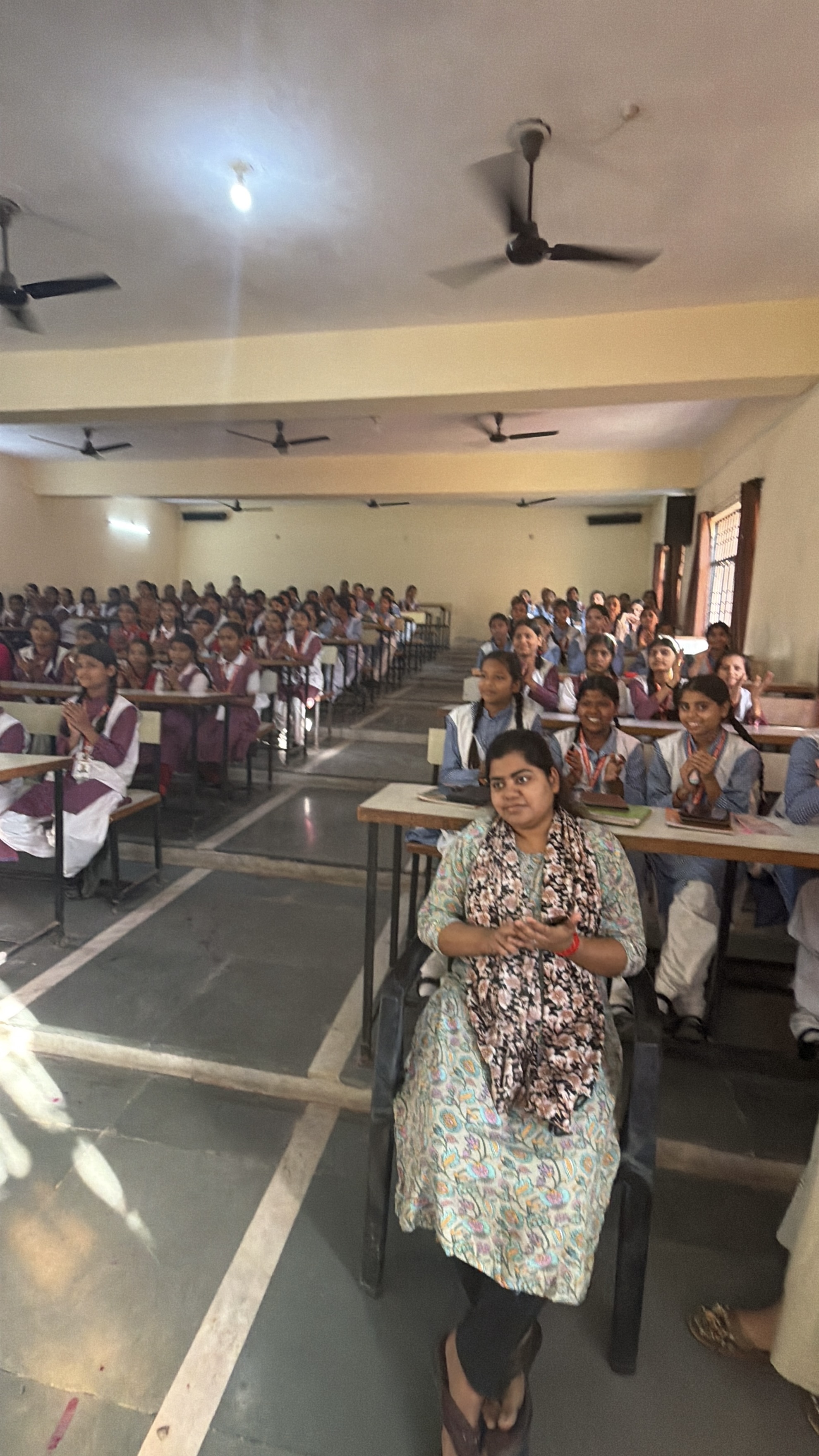 Students excitedly raising their hands during the intro session with Youth for Yoga