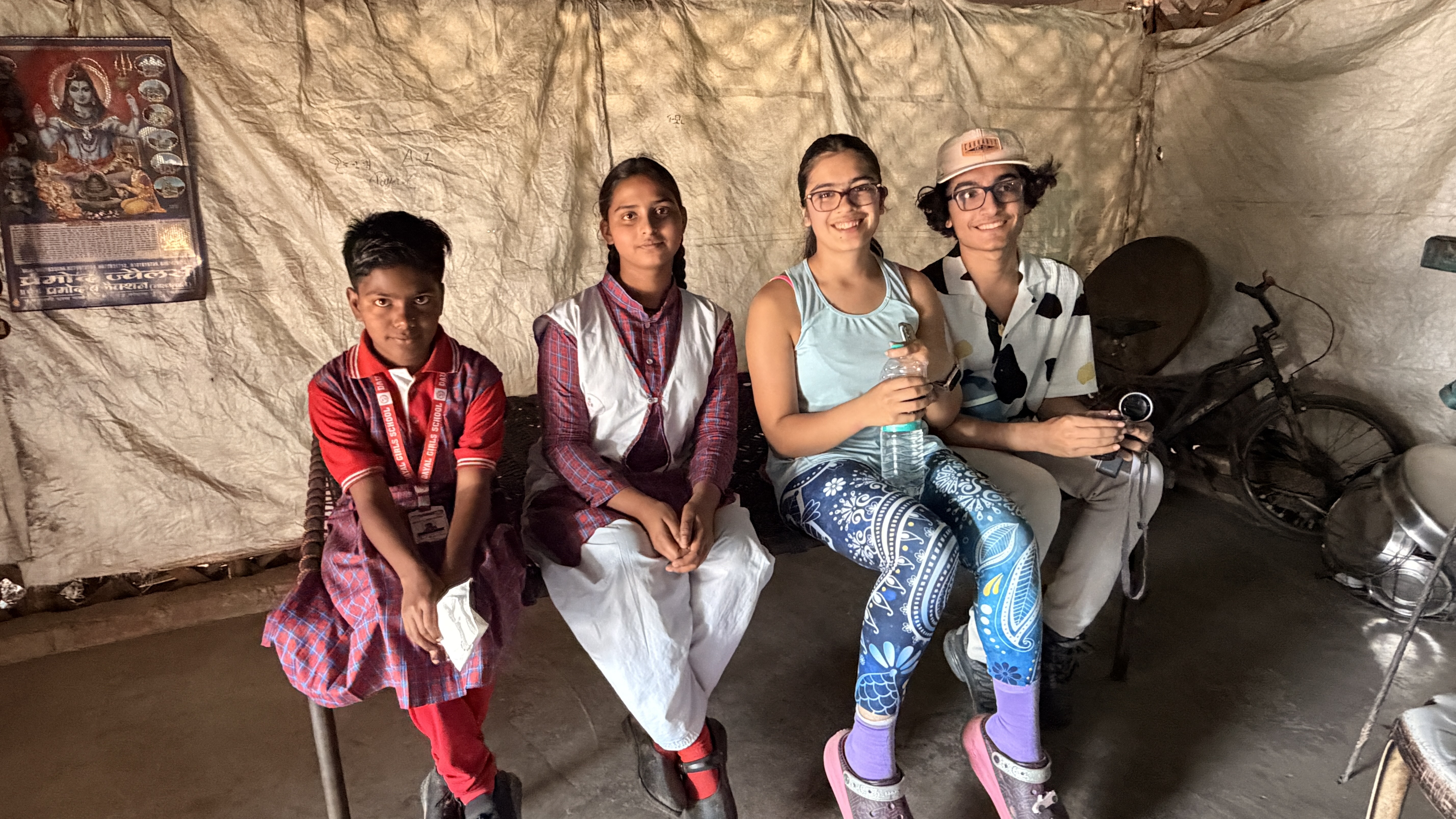 Youth for Yoga members with a student and their family inside their home in Uttar Pradesh