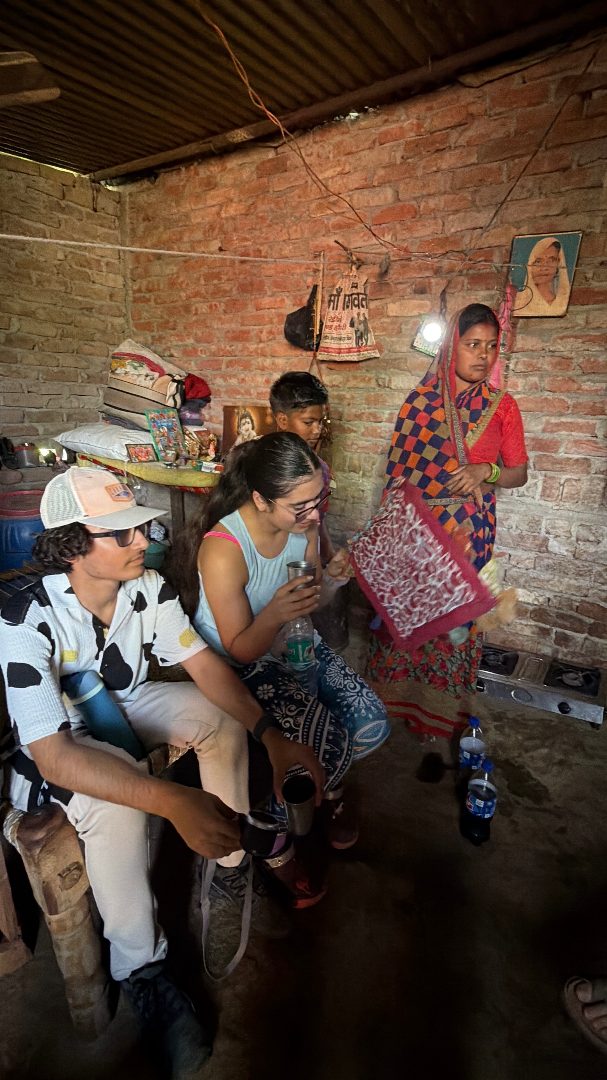 Shared moments with a student and their family during a home visit in Ferozabad