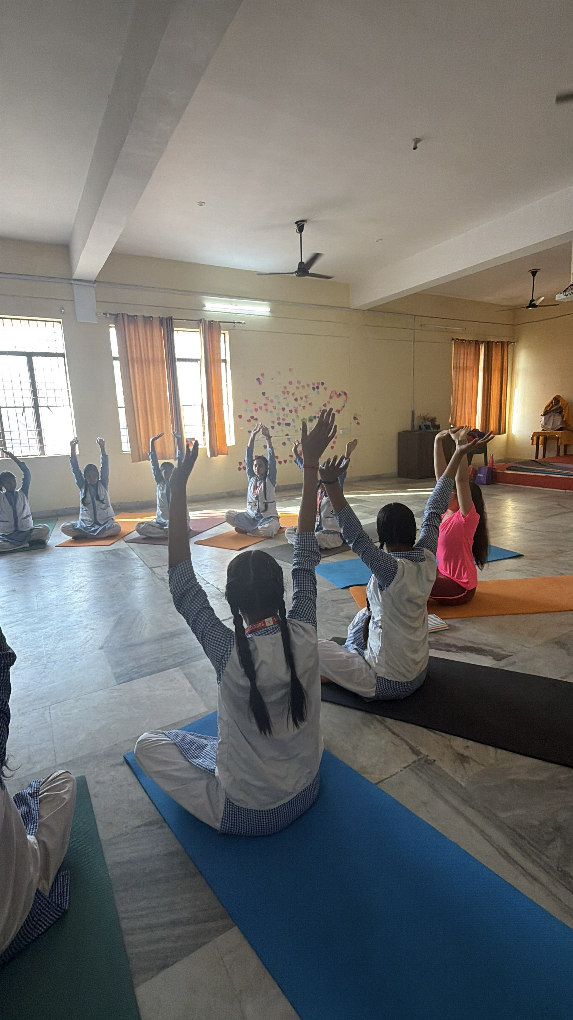Students sitting in meditation posture during a Youth for Yoga session in Ferozabad