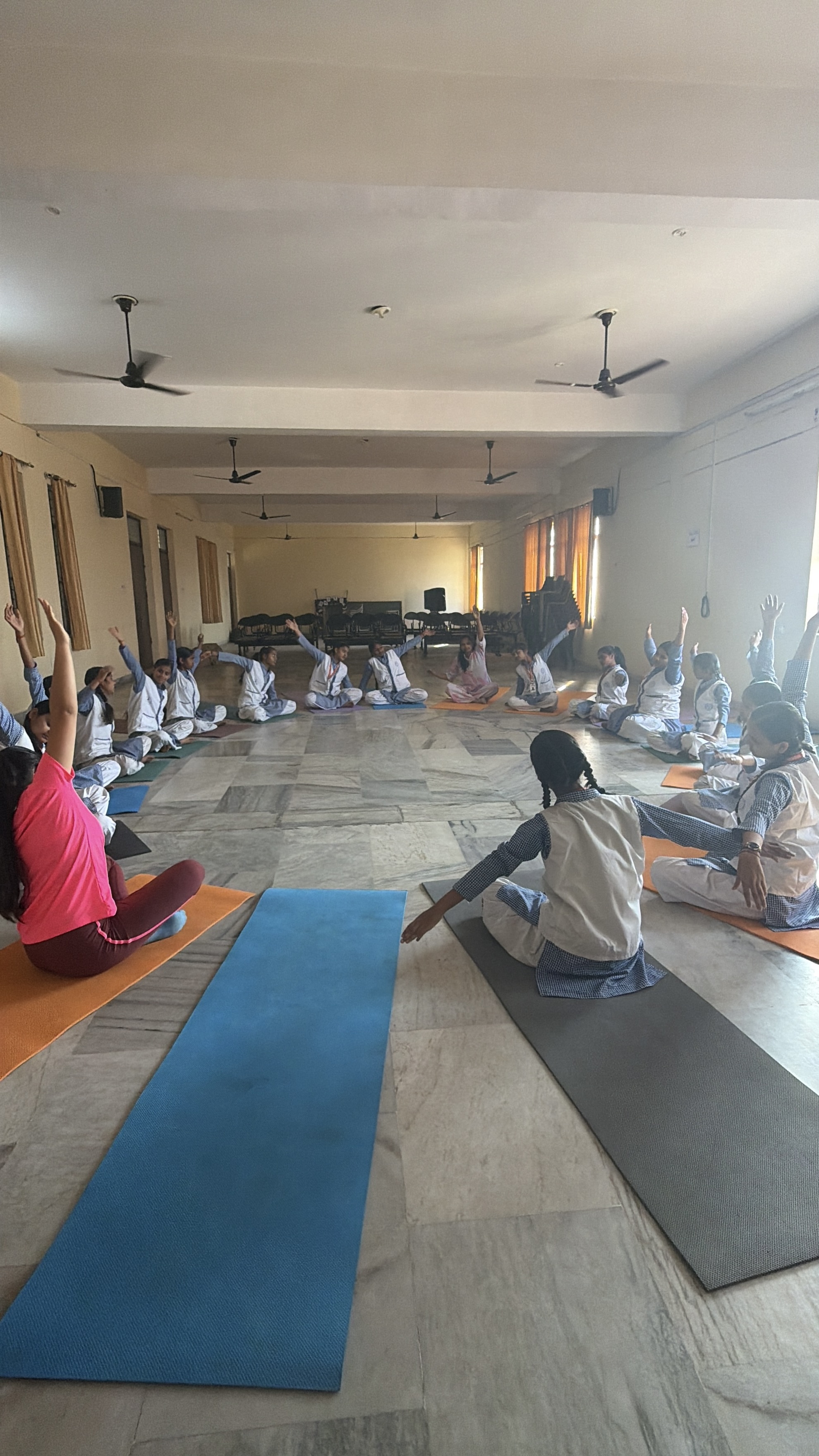 Students smiling while holding yoga poses during a Youth for Yoga class in Ferozabad