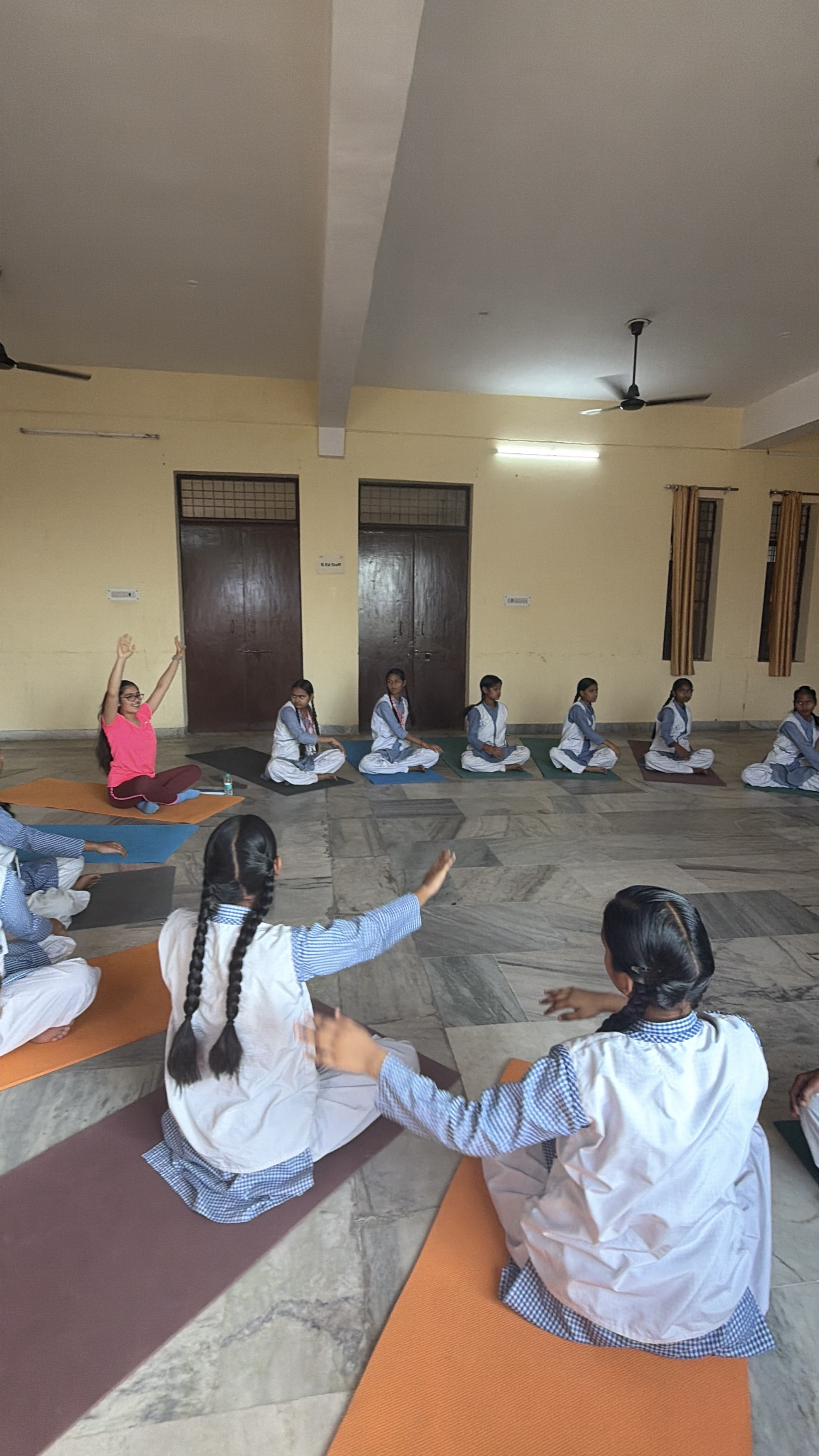 Wide shot of a large yoga class led by Youth for Yoga at a school in Ferozabad