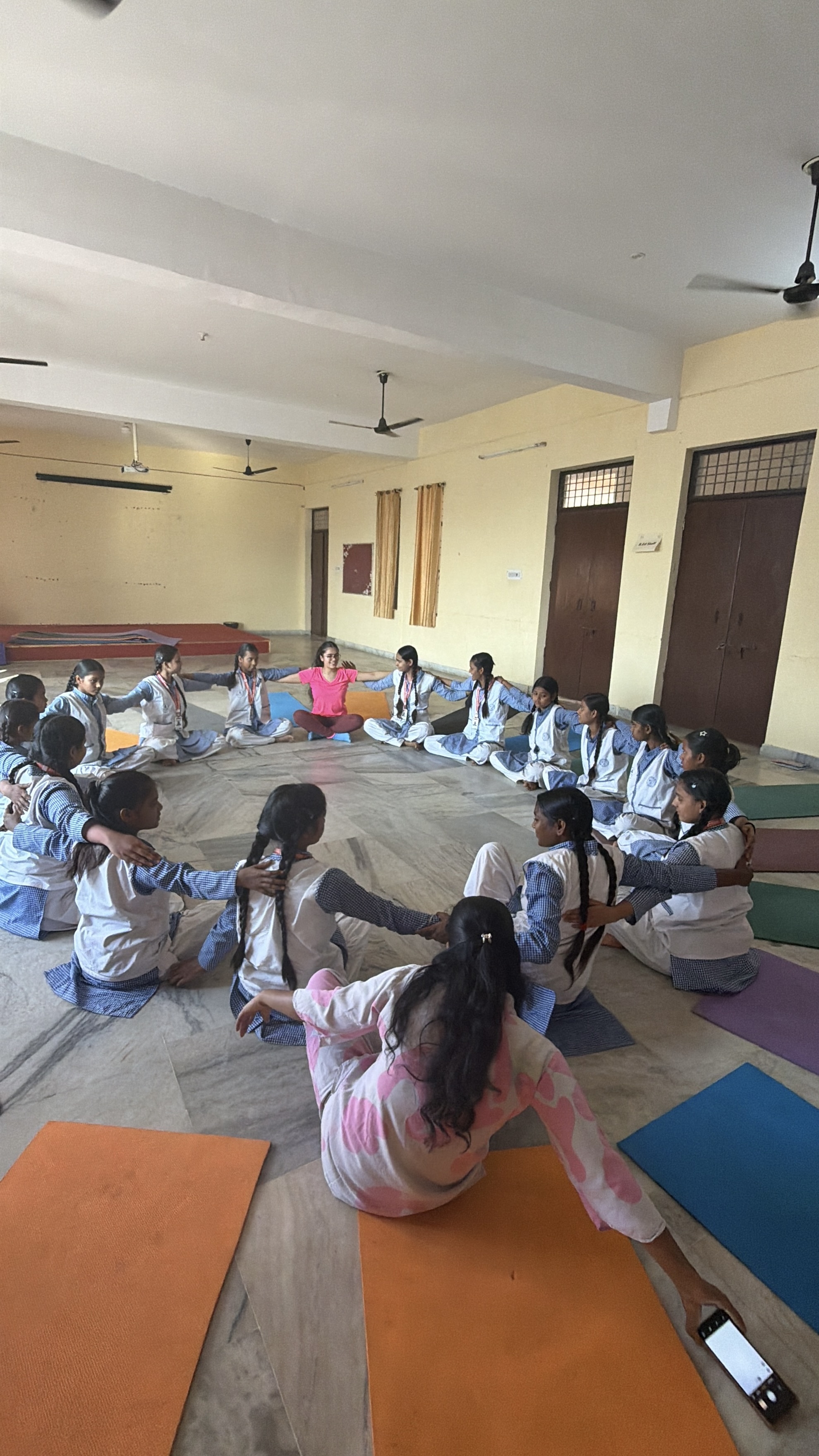 Students practicing warrior pose during a Youth for Yoga session in Ferozabad