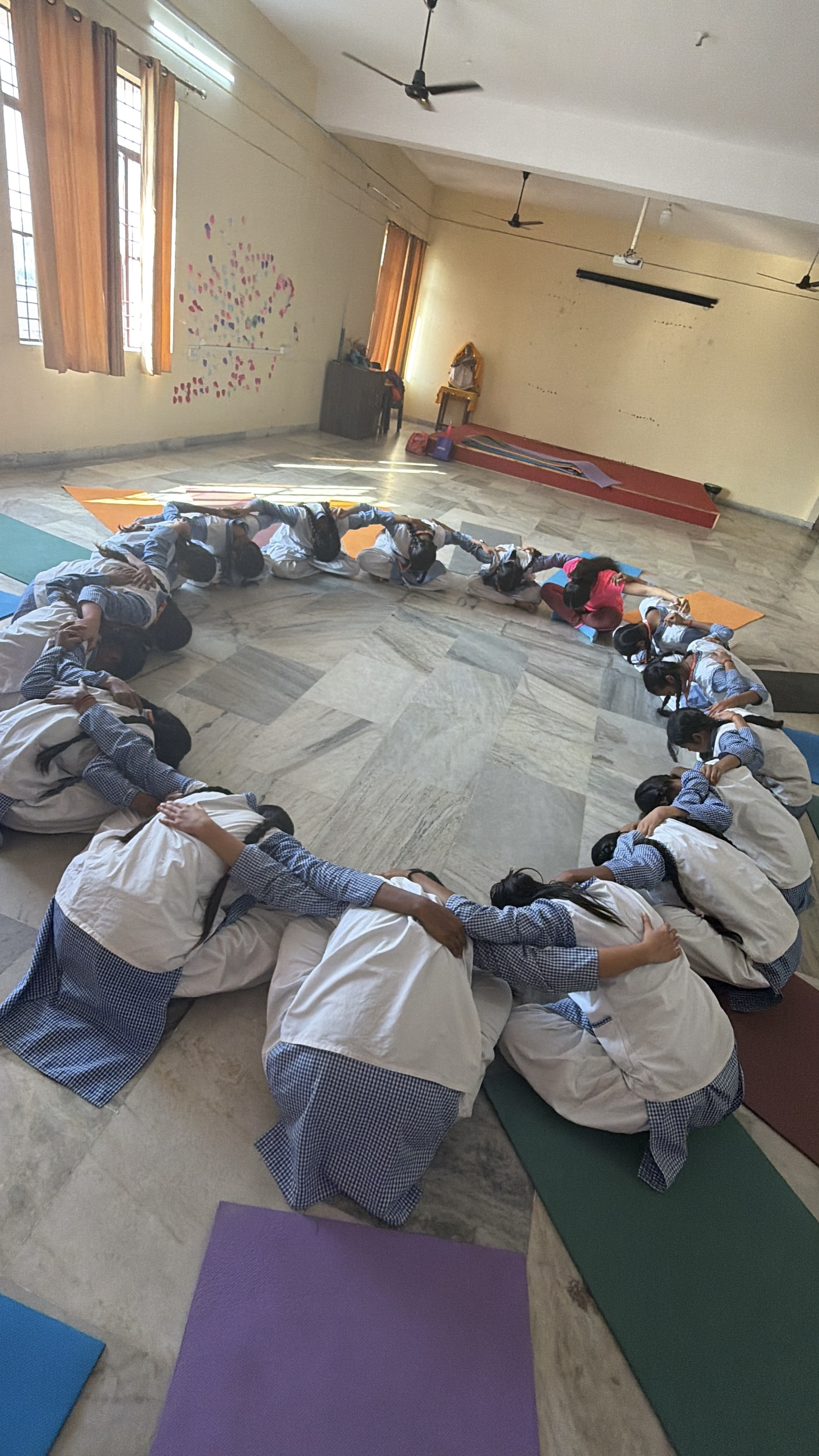 Youth for Yoga team with a full classroom of students during a yoga lesson in Ferozabad
