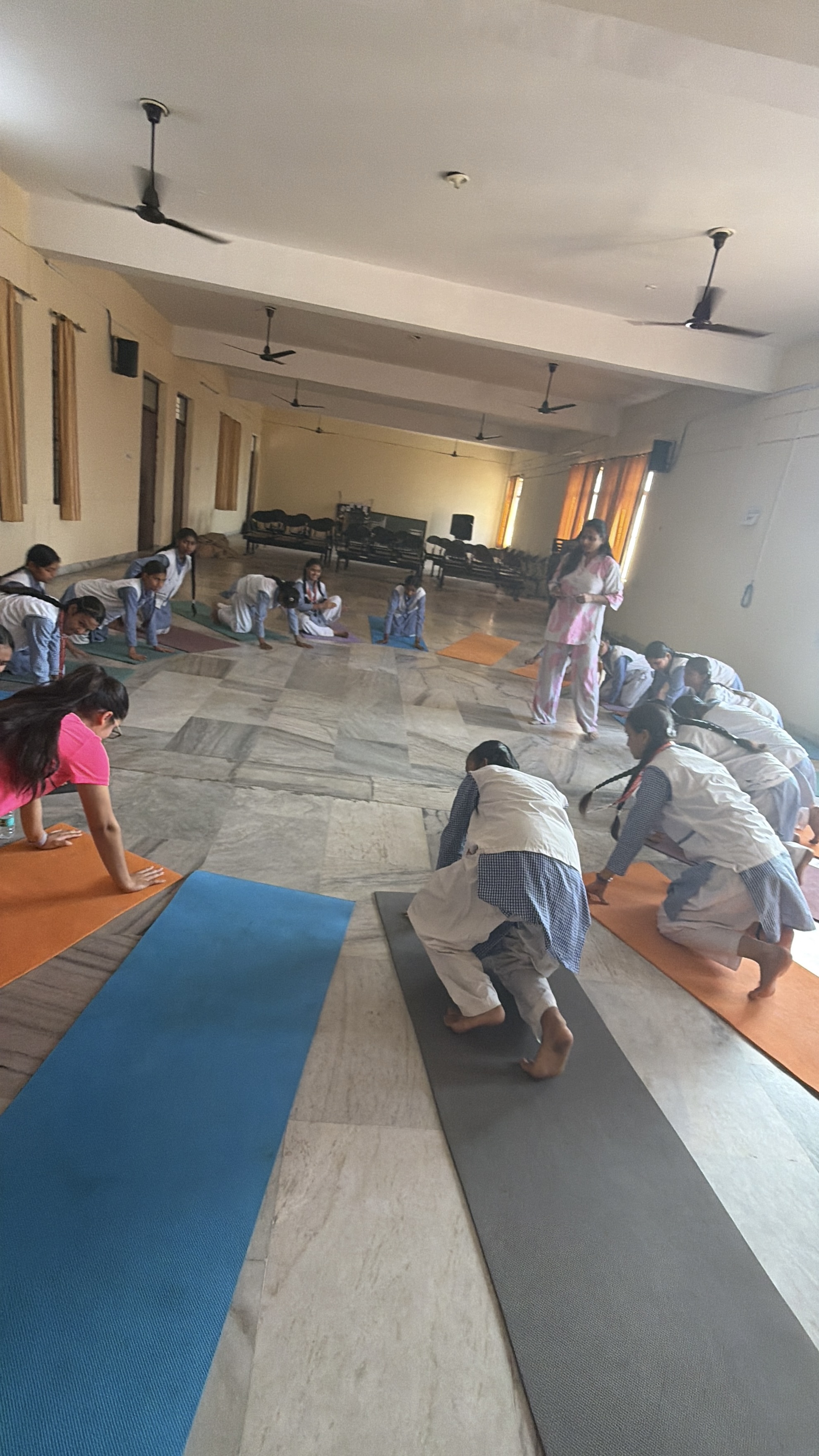 Youth for Yoga team teaching breathing techniques to a class of students in Uttar Pradesh