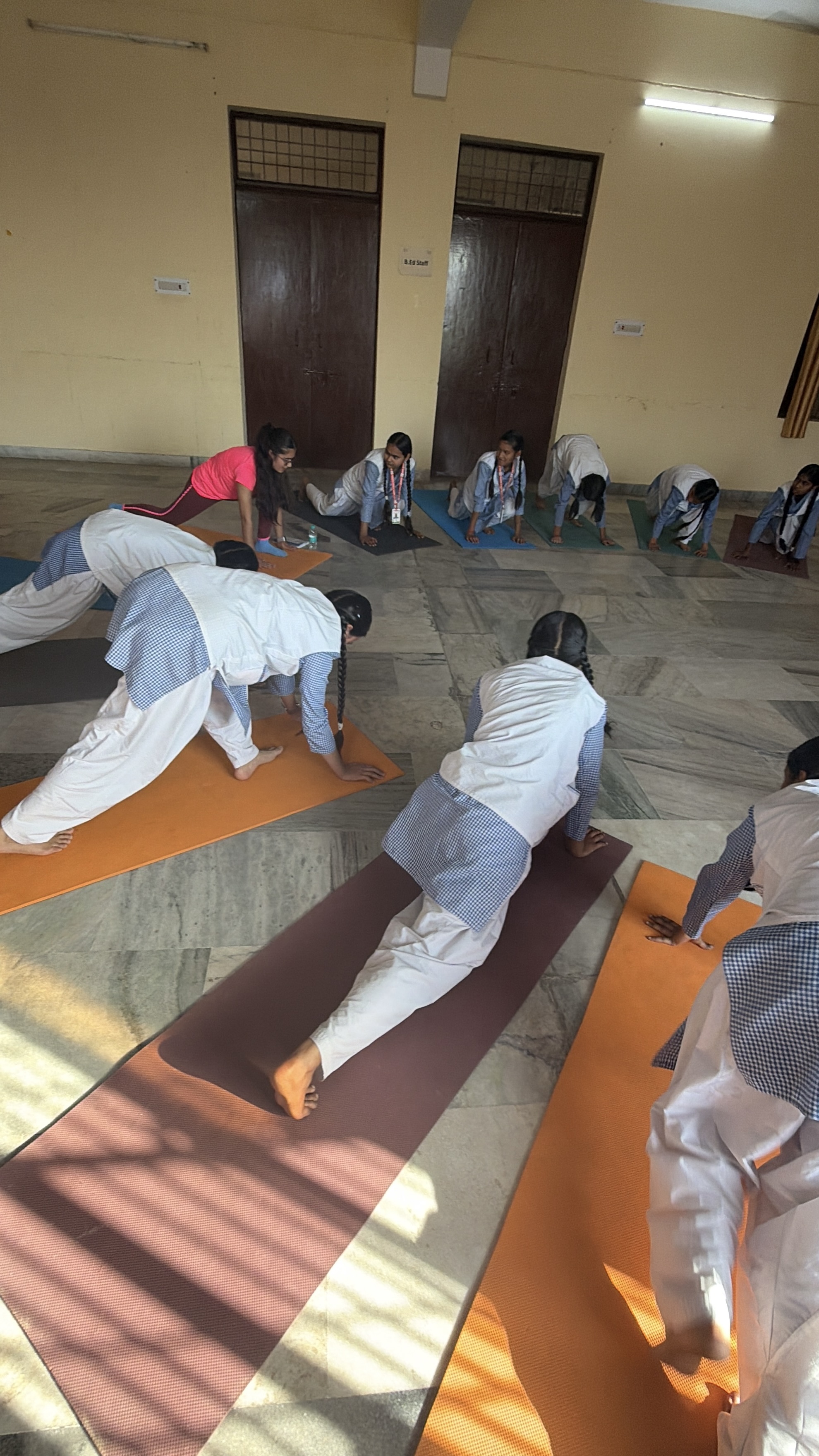 Youth for Yoga class in a school courtyard — students practicing outside in Ferozabad