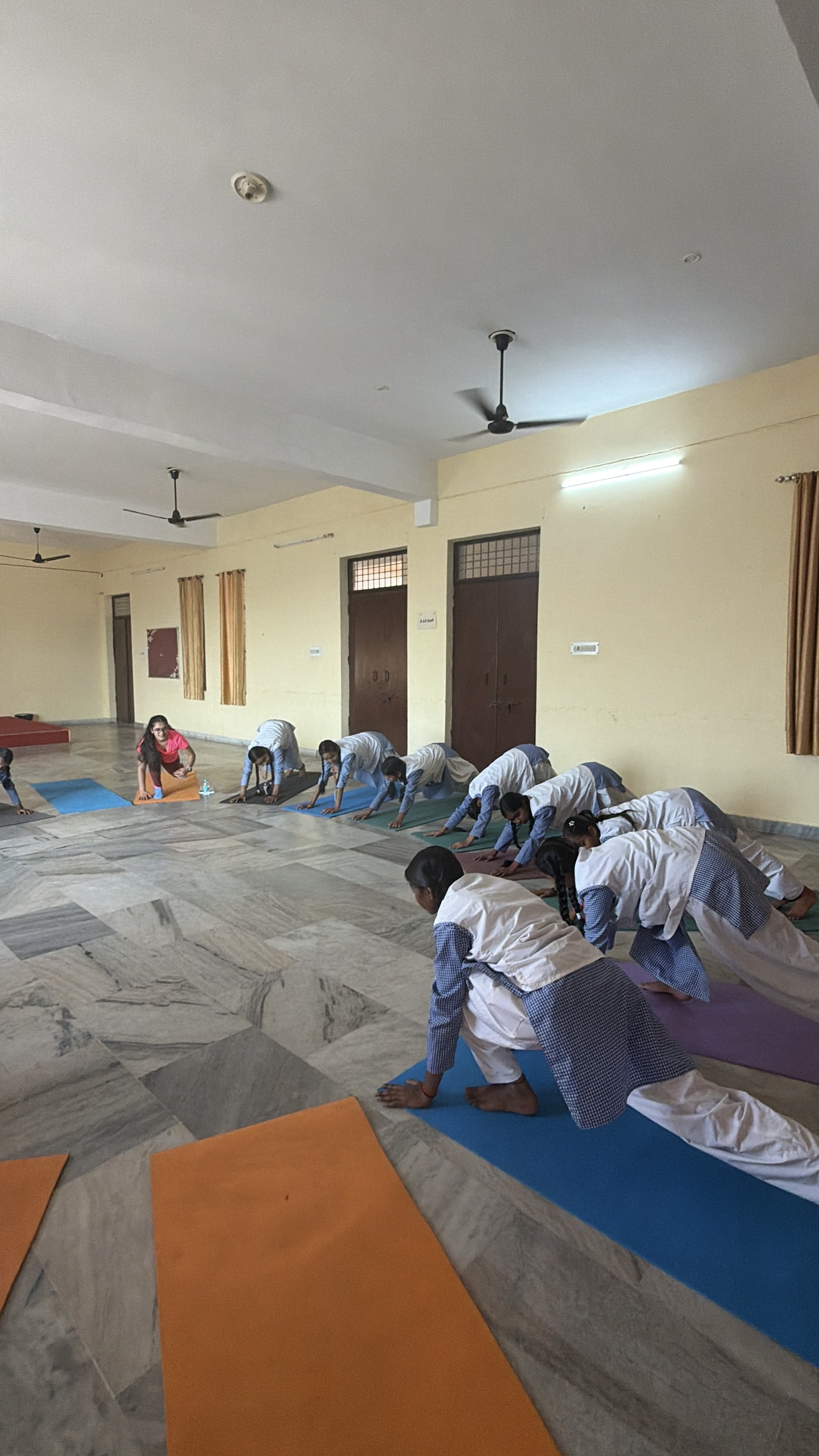 Large group of students and Youth for Yoga team celebrating at the end of a class in Ferozabad