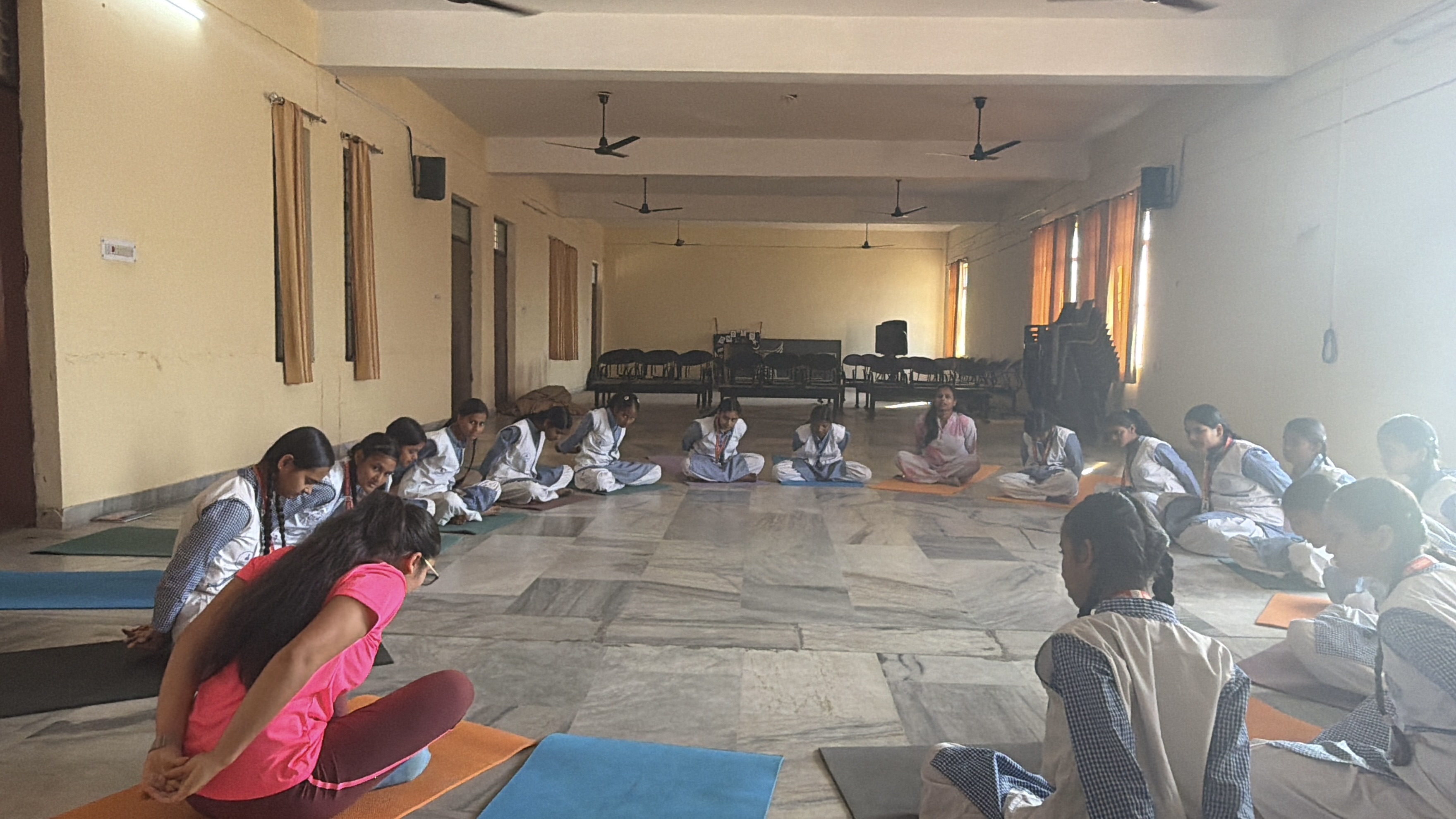 Youth for Yoga team teaching a yoga class to students at a school in Ferozabad, India