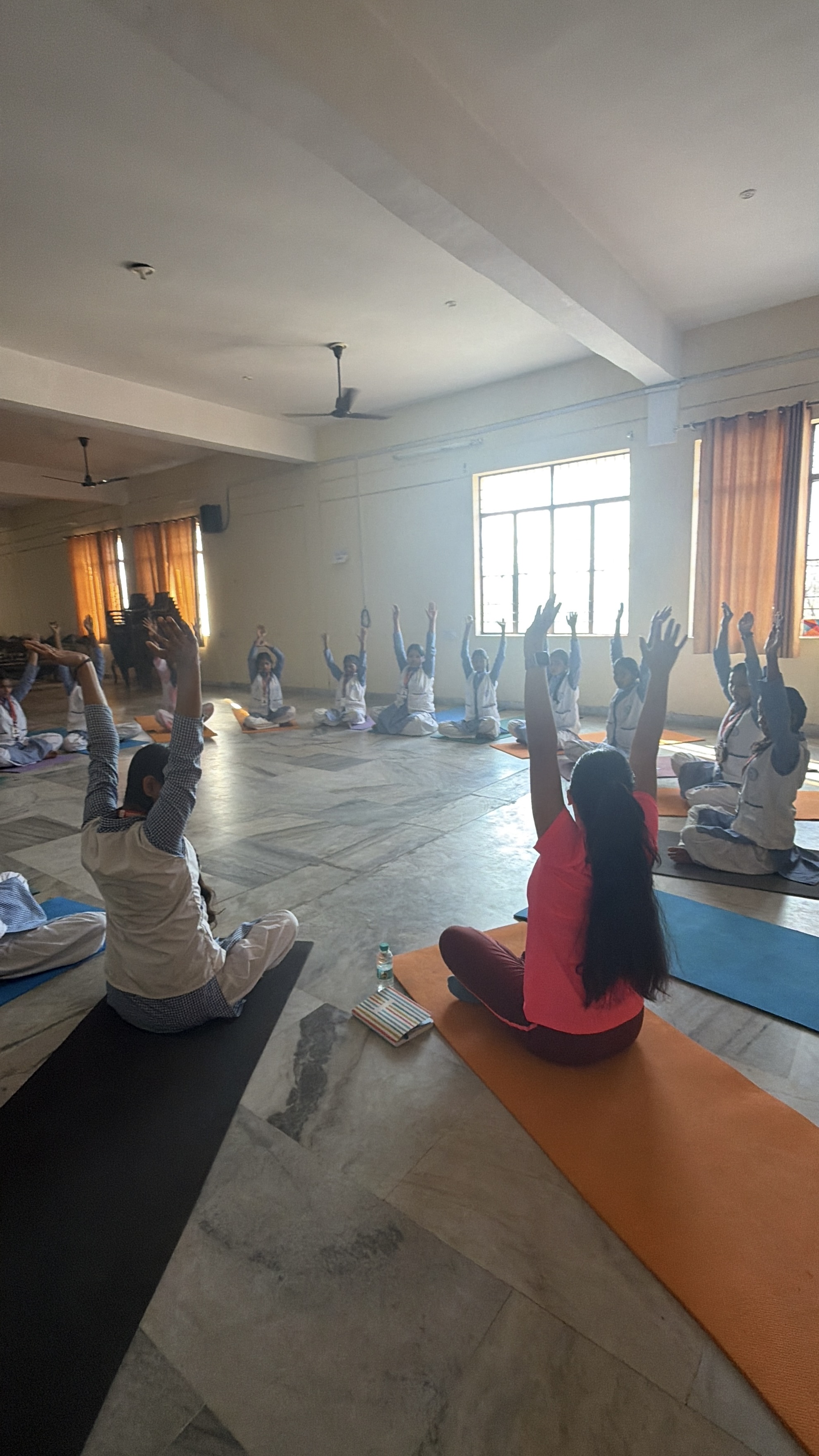 Youth for Yoga team teaching yoga to students in Ferozabad, India